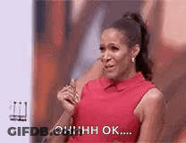 A Woman In A Red Dress Is Crying On A Stage And Saying `` Ohhhh Ok ... '' . GIF