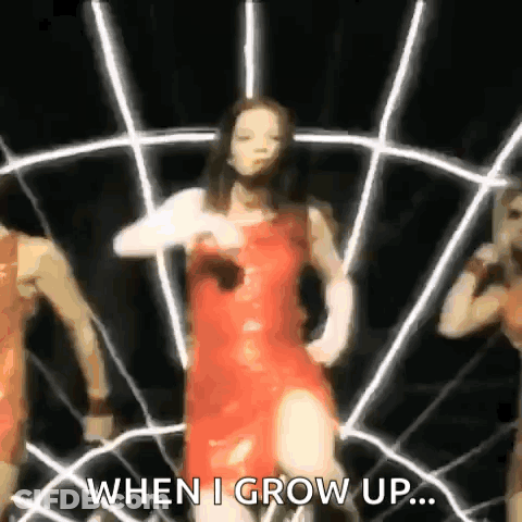 A Woman In A Red Dress Is Dancing In Front Of A Spider Web With The Words `` When I Grow Up ... '' GIF