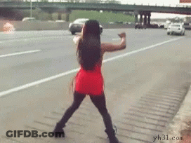 A Woman In A Red Dress Is Dancing On A Highway GIF