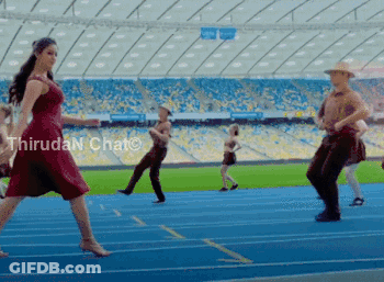 A Woman In A Red Dress Is Dancing On A Track In A Stadium With Thiruda N Chat Written In The Corner GIF