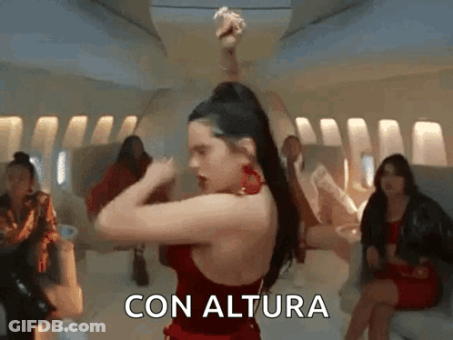 A Woman In A Red Dress Is Dancing On An Airplane With The Words Con Altura Written On The Bottom . GIF