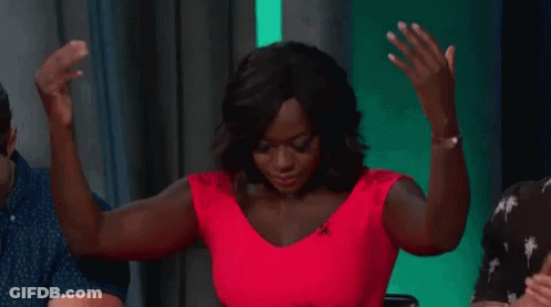 A Woman In A Red Dress Is Dancing With Her Arms In The Air . GIF