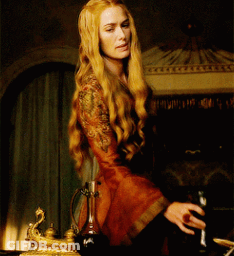 A Woman In A Red Dress Is Holding A Bottle Of Wine GIF