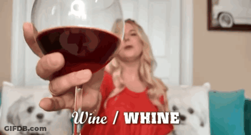 A Woman In A Red Dress Is Holding A Glass Of Wine With The Words Wine / Whine Above Her GIF