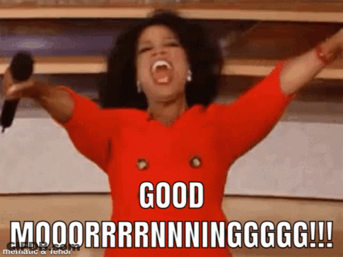 A Woman In A Red Dress Is Holding A Microphone With Her Arms In The Air And Says " Good " GIF