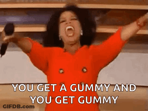 A Woman In A Red Dress Is Holding A Microphone With Her Arms Outstretched And Screaming . GIF