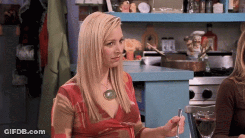 A Woman In A Red Dress Is Holding A Spoon In Her Hand GIF