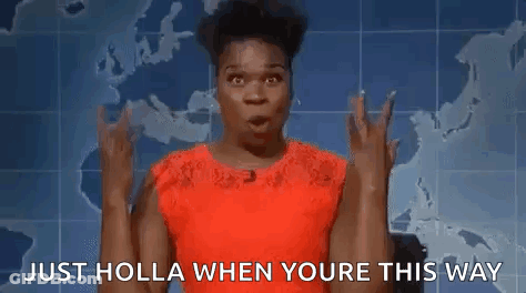 A Woman In A Red Dress Is Making A Devil Horns Gesture . GIF