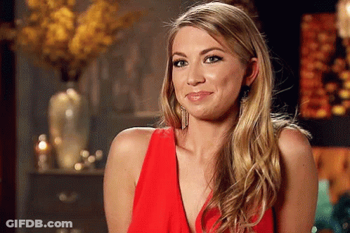 A Woman In A Red Dress Is Making A Face GIF