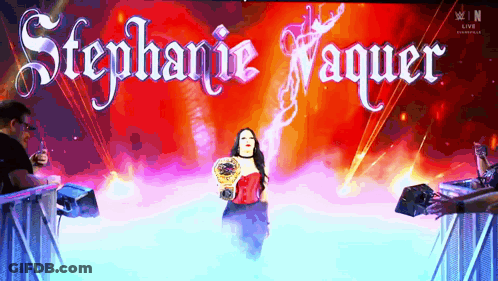 A Woman In A Red Dress Is On A Stage With The Name Stephanie Vaquer GIF