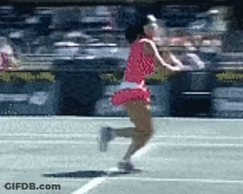 A Woman In A Red Dress Is Running On The Tennis Court GIF