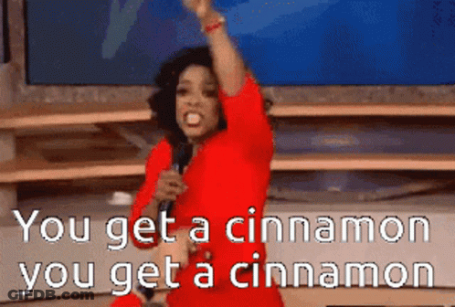 A Woman In A Red Dress Is Singing Into A Microphone With The Words You Get A Cinnamon You Get A Cinnamon GIF