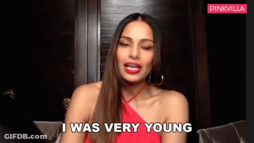 A Woman In A Red Dress Is Sitting On A Couch And Saying I Was Very Young GIF
