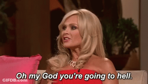 A Woman In A Red Dress Is Sitting On A Couch And Talking To Someone . GIF