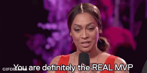 A Woman In A Red Dress Is Speaking Into A Microphone And Saying `` You Are Definitely The Real Mvp '' . GIF
