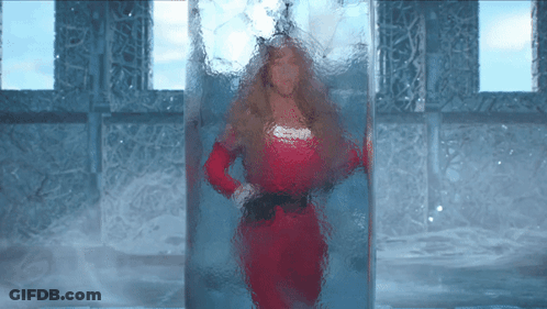 Woman In Red Dress Standing In Glass Container GIF