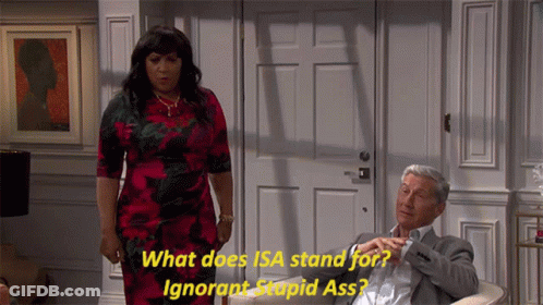 A Woman In A Red Dress Is Standing Next To A Man In A Suit Who Is Sitting In A Chair GIF