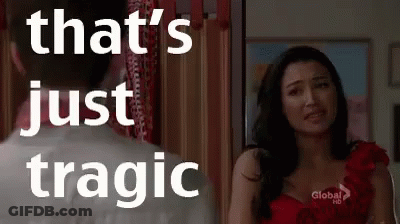 A Woman In A Red Dress Is Standing Next To A Man In A White Shirt And Looking At Him . GIF