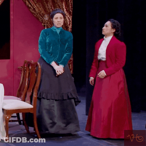 A Woman In A Red Dress Is Standing Next To Another Woman In A Blue Jacket And The Words Please No Are Above Them GIF