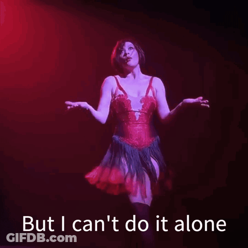 A Woman In A Red Dress Is Standing On A Stage With The Words But I Can 'T Do It Alone Below Her GIF