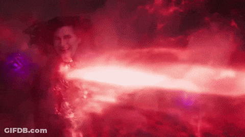 A Woman In A Red Dress Is Surrounded By Red Smoke And A Red Light . GIF