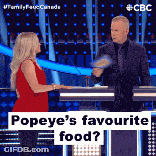 A Woman In A Red Dress Is Talking To A Man In A Suit On A Television Show Called Family Feud Canada GIF