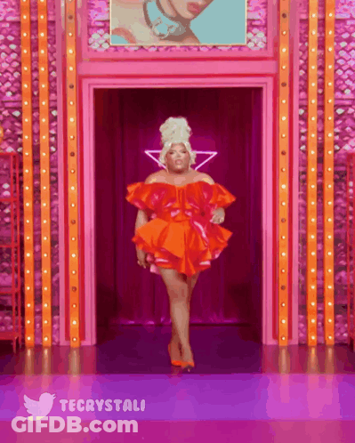 Woman In Red Dress Walking Down Runway With Twitter Logo GIF