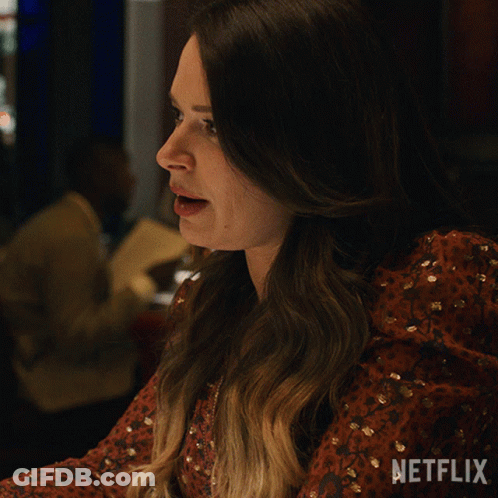 A Woman In A Red Dress Says Dramatic Much On A Netflix Ad GIF