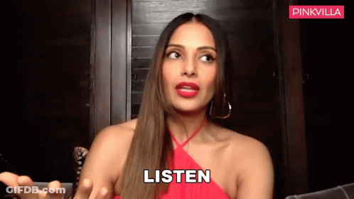 A Woman In A Red Dress Says Listen With Her Hands Out GIF