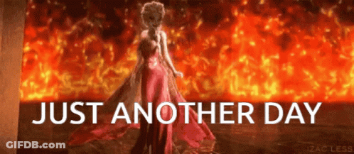 A Woman In A Red Dress Stands In Front Of A Fire With The Words Just Another Day Below Her GIF