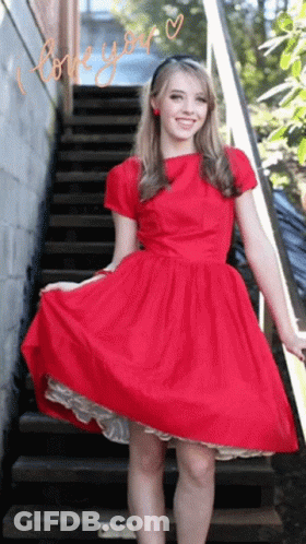 A Woman In A Red Dress Stands On A Set Of Stairs With The Words " I Love You " Written On The Bottom GIF