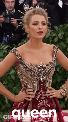 A Woman In A Red Dress With The Word Queen On The Bottom Right GIF