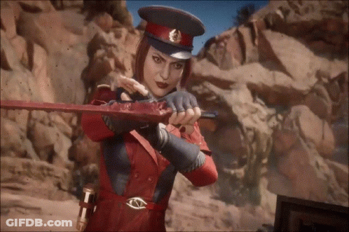 A Woman In A Red Hat Is Holding A Bloody Sword In Her Hands . GIF