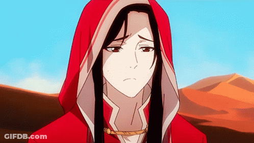 A Woman In A Red Hooded Jacket Is Standing In Front Of A Desert GIF