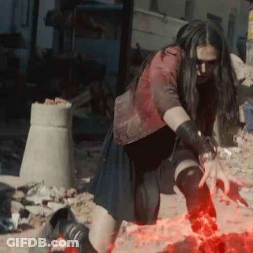 Woman In Red Jacket And Black Skirt Kneeling In Dirt GIF