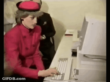 A Woman In A Red Jacket And Hat Is Typing On A Computer Keyboard . GIF