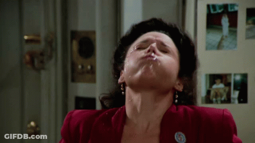 A Woman In A Red Jacket Has A Badge On Her Jacket That Says ' A ' On It GIF