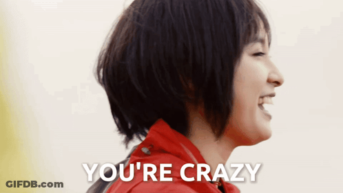 A Woman In A Red Jacket Is Laughing With The Words You 'Re Crazy Above Her GIF