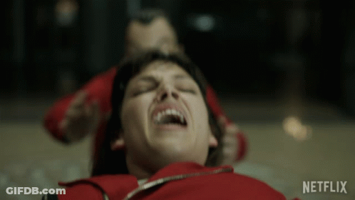 A Woman In A Red Jacket Is Laying On The Floor With A Netflix Logo In The Corner GIF