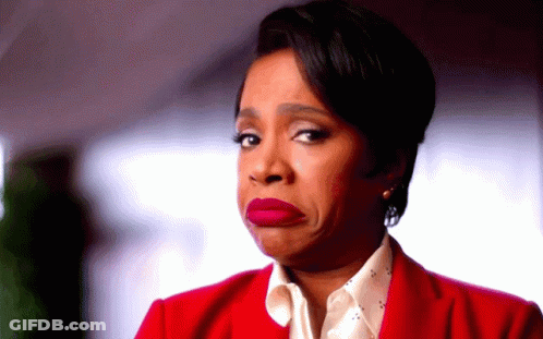 A Woman In A Red Jacket Is Making A Face GIF