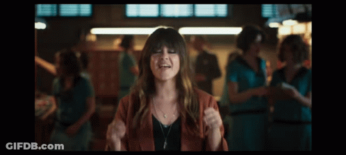 A Woman In A Red Jacket Is Making Funny Faces GIF