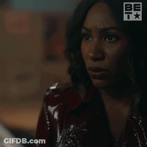 A Woman In A Red Jacket Is Saying Wait . GIF