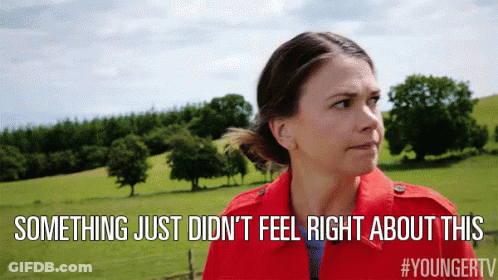 A Woman In A Red Jacket Is Standing In A Field With The Words Something Just Did N't Feel Right About This Above Her GIF