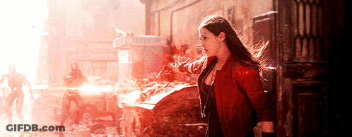 Woman In Red Jacket Standing In Front Of Phone Booth GIF