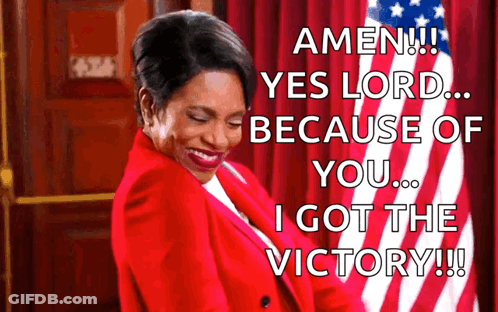 A Woman In A Red Jacket Is Standing In Front Of An American Flag And Says Amen Yes Lord Because Of You I Got The Victory GIF