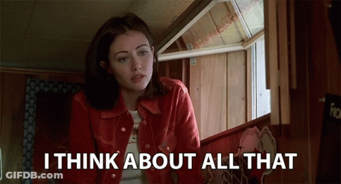 A Woman In A Red Jacket Says " I Think About All That " In Front Of A Window GIF