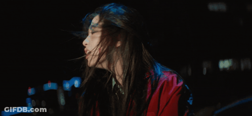 A Woman In A Red Jacket With Her Mouth Open GIF