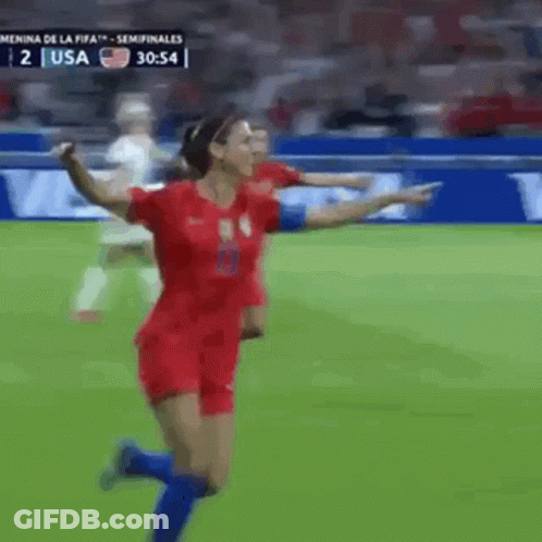 A Woman In A Red Jersey Is Running On A Soccer Field During A Game Against The Usa GIF