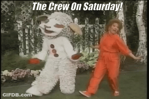 A Woman In A Red Jumpsuit Is Dancing Next To A Snowman In A White Outfit . GIF