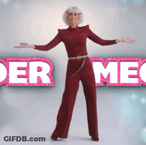 A Woman In A Red Jumpsuit Stands In Front Of A Sign That Says " Der Meg " GIF